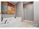 Elegant bathroom featuring a soaking tub with modern fixtures and a separate glass-enclosed shower at 7122 Abbotts Glen Dr, Charlotte, NC 28212