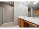 Bright bathroom with a sleek vanity, a large mirror, and a separate shower room at 7122 Abbotts Glen Dr, Charlotte, NC 28212