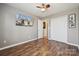 Bedroom with closet space, wood flooring, and a mounted TV for entertainment at 7122 Abbotts Glen Dr, Charlotte, NC 28212