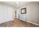 Bedroom with closet space, a dresser, wood floors, and neutral paint at 7122 Abbotts Glen Dr, Charlotte, NC 28212