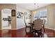 Dining area showcasing hardwood floors, stylish decor, arched openings, and a cozy atmosphere at 7122 Abbotts Glen Dr, Charlotte, NC 28212