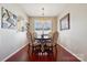 Dining room featuring hardwood floors, a chandelier, a window with shutters, and an arched doorway at 7122 Abbotts Glen Dr, Charlotte, NC 28212