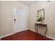 Entryway featuring a stylish mirror, modern door hardware, hardwood floors, and a crisp white front door at 7122 Abbotts Glen Dr, Charlotte, NC 28212