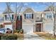 Charming townhome with a well-maintained front yard and attached garage, featuring a mix of brick and vinyl siding at 7122 Abbotts Glen Dr, Charlotte, NC 28212