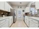 Well lit kitchen with white cabinets, stainless steel appliances, and access to the backyard at 7122 Abbotts Glen Dr, Charlotte, NC 28212