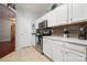 Well-equipped kitchen with stainless steel appliances, white cabinets, and modern tile backsplash at 7122 Abbotts Glen Dr, Charlotte, NC 28212