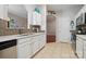 Spacious kitchen featuring white cabinets, stainless steel appliances, and a stylish tile backsplash at 7122 Abbotts Glen Dr, Charlotte, NC 28212