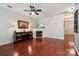 Cozy living room with hardwood floors, a fireplace, TV, decorative shelves, and ample natural light at 7122 Abbotts Glen Dr, Charlotte, NC 28212