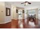 Open-concept living area with hardwood floors flowing into a dining space and kitchen, creating a welcoming atmosphere at 7122 Abbotts Glen Dr, Charlotte, NC 28212