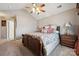 Cozy main bedroom with ceiling fan, nightstands, and doorway to other rooms at 7122 Abbotts Glen Dr, Charlotte, NC 28212