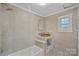 Updated bathroom with beige tile, a modern vanity, and a large shower at 1000 Bond Ave, Gastonia, NC 28052