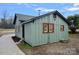 Side view of a charming green house with a concrete driveway at 1000 Bond Ave, Gastonia, NC 28052