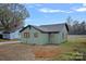 Rear view of a renovated home with green siding and a small yard at 1000 Bond Ave, Gastonia, NC 28052