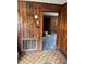 Hallway with wood walls and vintage tile floor at 111 James Love School Rd, Shelby, NC 28152