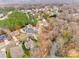 A serene aerial view of a home with a lakeside view in a neighborhood with mature trees and winding streets at 1345 Shimmer Light Cir, Rock Hill, SC 29732