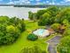 An aerial view showcases a community pool near the lake, surrounded by verdant trees and manicured lawns at 1345 Shimmer Light Cir, Rock Hill, SC 29732