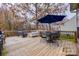 Inviting back deck with outdoor seating, dining table, and grill beneath mature trees at 1345 Shimmer Light Cir, Rock Hill, SC 29732