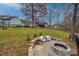 Backyard featuring a fire pit area with built-in seating, perfect for outdoor entertaining at 1345 Shimmer Light Cir, Rock Hill, SC 29732