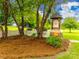 A stone sign marks Sunset Point, surrounded by trees and white picket fence at 1345 Shimmer Light Cir, Rock Hill, SC 29732