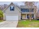 Two-story house with beige siding, blue shutters, and a double-car garage at 1345 Shimmer Light Cir, Rock Hill, SC 29732