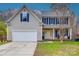 Inviting two-story home featuring blue shutters, a yellow front door, and an attached garage at 1345 Shimmer Light Cir, Rock Hill, SC 29732