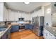 Well-lit kitchen boasts stainless steel appliances, butcher block counters and hardwood floors at 1345 Shimmer Light Cir, Rock Hill, SC 29732