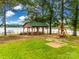 Lakeside pavilion with picnic tables and a swing overlooking the water at 1345 Shimmer Light Cir, Rock Hill, SC 29732