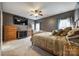 Main bedroom features a ceiling fan, neutral paint and carpet, and a large TV at 1345 Shimmer Light Cir, Rock Hill, SC 29732