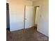 A basic bedroom featuring carpeted flooring and a doorway with an open door at 1406 Milan Rd, Charlotte, NC 28216