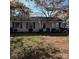 Cozy single-story home with blue shutters and mature trees in a residential neighborhood at 1406 Milan Rd, Charlotte, NC 28216