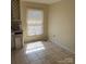 A kitchen area with tile flooring and a window at 1406 Milan Rd, Charlotte, NC 28216