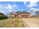 Brick home's exterior boasts a two-car garage and curb appeal at 1490 Kensington Park Ct, Hickory, NC 28602