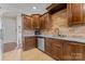 Modern kitchen with dark wood cabinets, granite countertops, and stainless steel appliances at 1490 Kensington Park Ct, Hickory, NC 28602