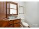 Simple half bathroom with wood cabinets and a pedestal sink at 1601 Bennington Nw Dr, Concord, NC 28027