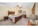 Cozy bedroom with wood furniture and ample natural light at 1601 Bennington Nw Dr, Concord, NC 28027