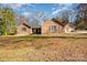 Brick ranch home with attached two-car garage and landscaped yard at 1601 Bennington Nw Dr, Concord, NC 28027