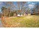 Ranch home with two-car garage, long driveway, and mature trees at 1601 Bennington Nw Dr, Concord, NC 28027