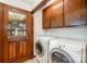 Laundry room with washer, dryer, and built-in cabinets at 1601 Bennington Nw Dr, Concord, NC 28027