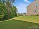 Large backyard with grassy area and trees at 17718 Snug Harbor Rd, Charlotte, NC 28278