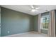 Bright bedroom with ceiling fan, window, and neutral walls at 17718 Snug Harbor Rd, Charlotte, NC 28278