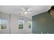 Bedroom with three windows, ceiling fan, and accent wall at 17718 Snug Harbor Rd, Charlotte, NC 28278