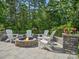 Stone fire pit surrounded by chairs on patio at 17718 Snug Harbor Rd, Charlotte, NC 28278