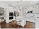 Modern kitchen with white cabinets, stainless steel appliances, and large island at 17718 Snug Harbor Rd, Charlotte, NC 28278