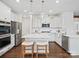 Bright kitchen featuring white cabinets, stainless steel appliances, and an island with seating at 17718 Snug Harbor Rd, Charlotte, NC 28278