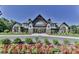 Community clubhouse with stone and wood exterior, landscaping, and a grand entrance at 236 Ascot Run Way, Fort Mill, SC 29715