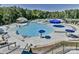 Resort-style community pool with expansive deck and multiple umbrellas at 236 Ascot Run Way, Fort Mill, SC 29715