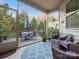 Cozy screened porch with patio furniture and lush landscaping at 236 Ascot Run Way, Fort Mill, SC 29715