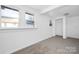 Simple bedroom with neutral carpeting and multiple windows at 304 Gold Hill Ave, Rockwell, NC 28138