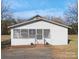 White house with a screened porch and landscaped yard at 304 Gold Hill Ave, Rockwell, NC 28138