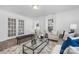 Open and airy living room with French doors leading to a sunroom at 304 Gold Hill Ave, Rockwell, NC 28138